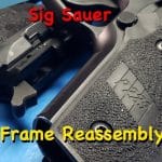 Sig Sauer Frame Assembly - Sig Sauer P229 pistol frame close-up showing grip and controls during reassembly