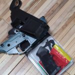 Tools and parts needed to assemble an AR-15 lower receiver laid out for a clean DIY build