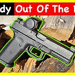 Timberwolf 17 pistol with optic shown on split firewood background